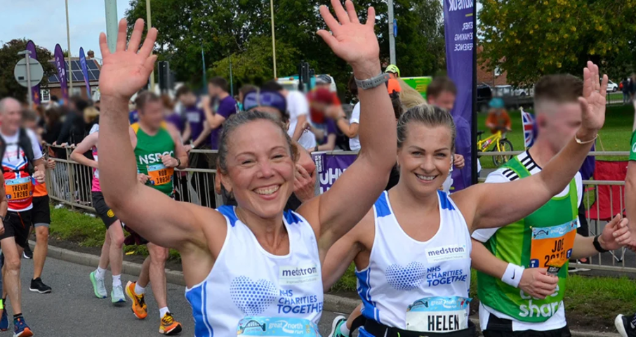 2 Women running in a race representing NHS Charities Together
